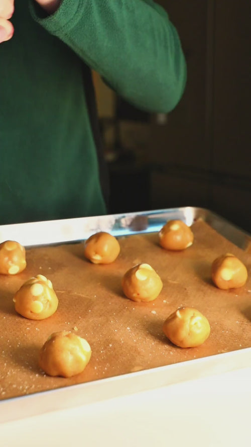 Cookie Cult cookies going into the oven, baked, and packed into a bag